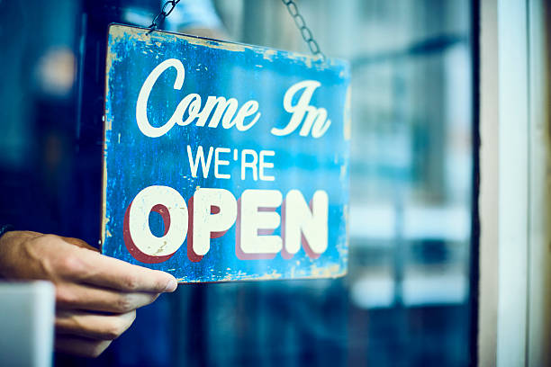 istock Barista hanging an open sign in restaurant 533975278