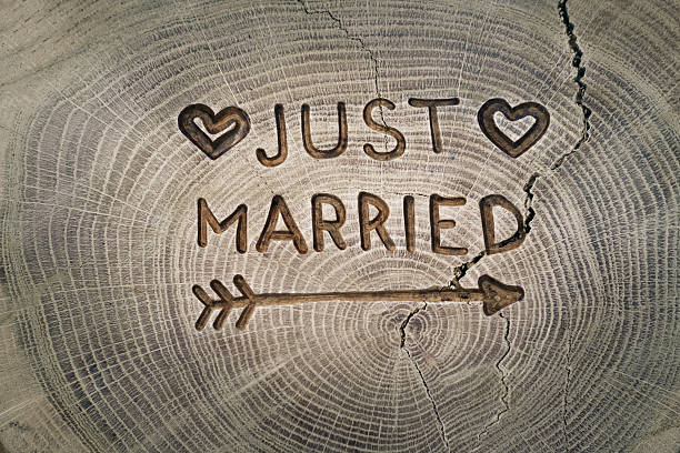 Woodcarving. Newlyweds, Just married, inscription on the wedding. Background stock photo