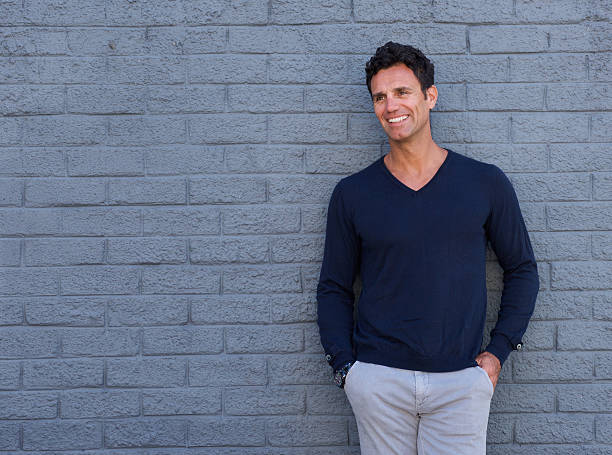 istock Attractive older man smiling against gray wall 533975852