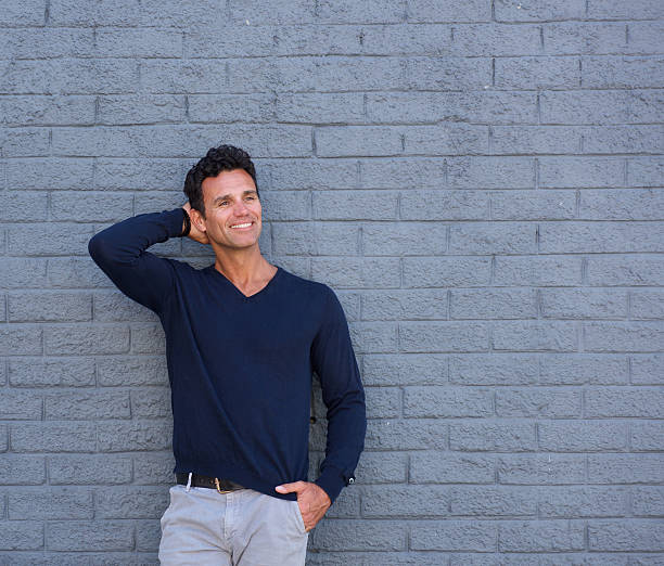 istock Handsome mature man smiling with hand in hair 533976882