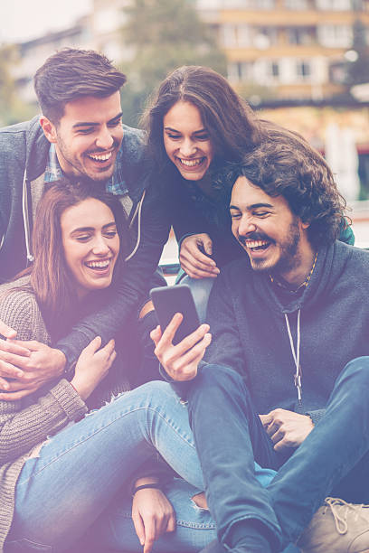 istock Friends sharing content on smart phone 533977086