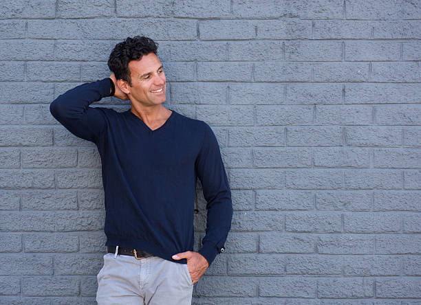 istock Confident man smiling with hand in hair 533977474