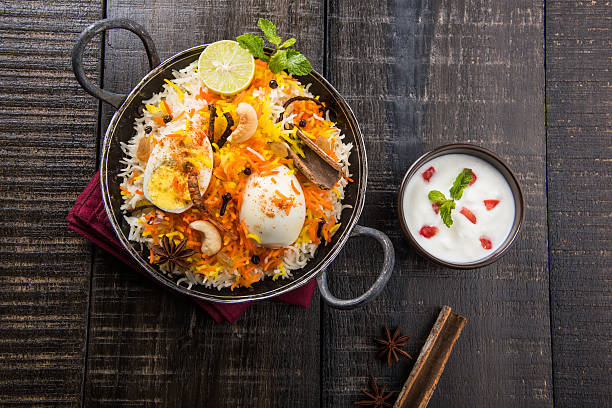 egg biryani or anda biryani using basmati rice and spices Basmati rice slowly cooked with Masala roasted egg and spices served in kadhai or kadai with yogurt dip, selective focus, egg biryani or anda rice or egg rice hyderabad india photos stock pictures, royalty-free photos & images