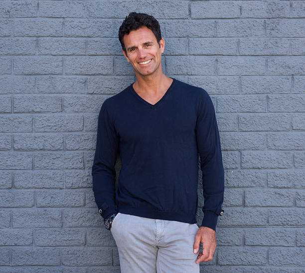 istock Handsome confident man smiling against gray wall 533978088