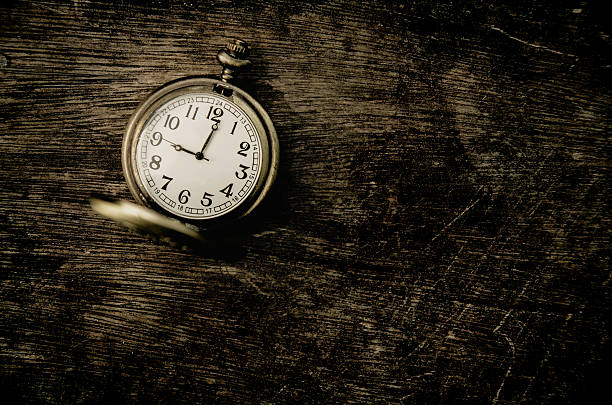 istock vintage pocket watch on grunge wood panel with copy space 533978300