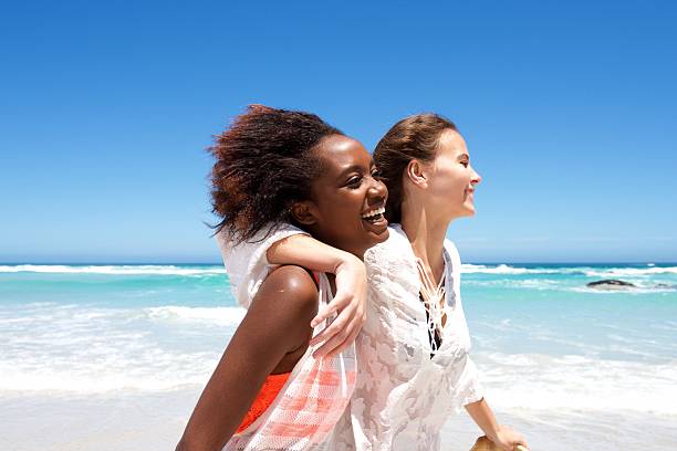 istock Smiling young female friends at the beach 533980904