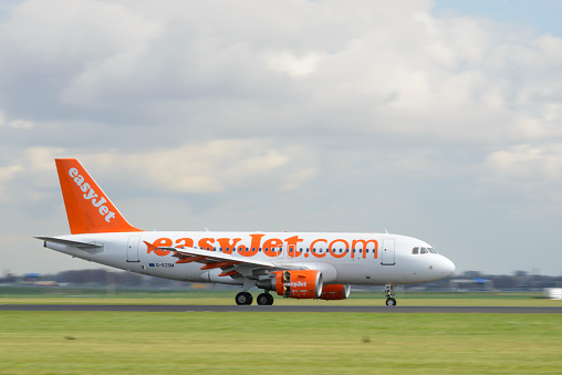 Schiphol, The Netherlands - April 8, 2016: EasyJet Airbus A319 landing at Amsterdam Airport Schiphol. The G-EZSM is part of the fleet of EasyJet, the British low-cost airline carrier easyJet.
