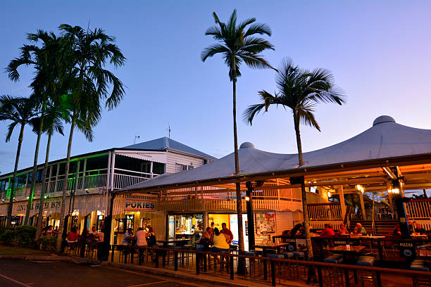 Pubs and restaurants  in Port Douglas Queensland Australia Port Douglas, Australia - April 19, 2016: People drink in Pubs and restaurants on the main street of Port Douglas a very popular travel destination in the tropical north of Queensland, Australia. port douglas photos stock pictures, royalty-free photos & images
