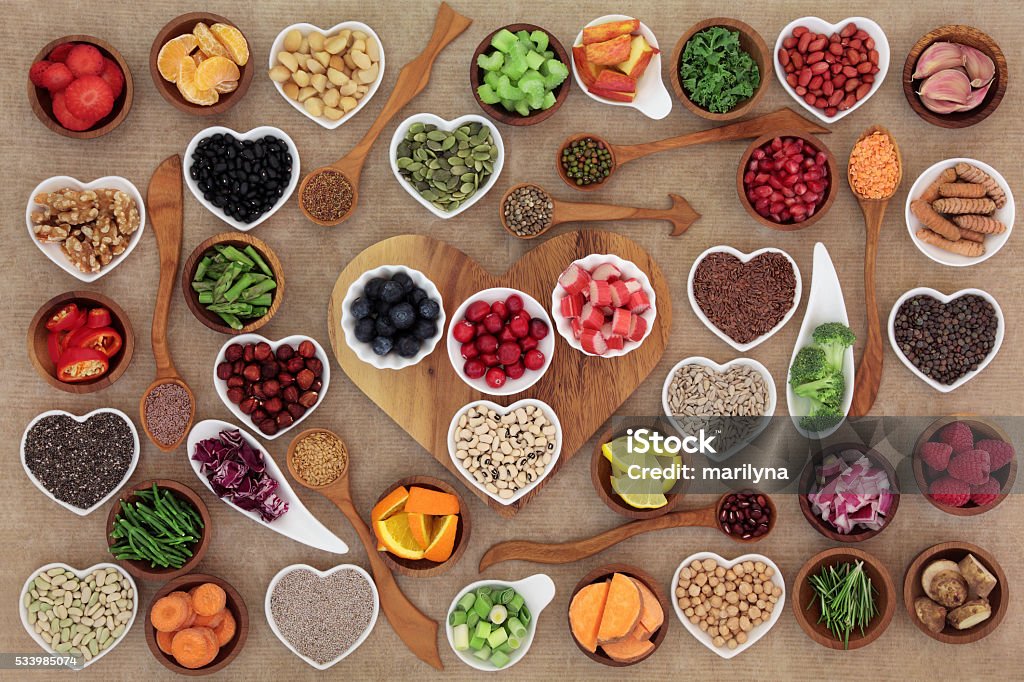 Super Food Selection Healthy super food  selection in wooden and porcelain china bowls and spoons. High in antioxidants, vitamins, minerals and anthocyanins. Heart Shape Stock Photo