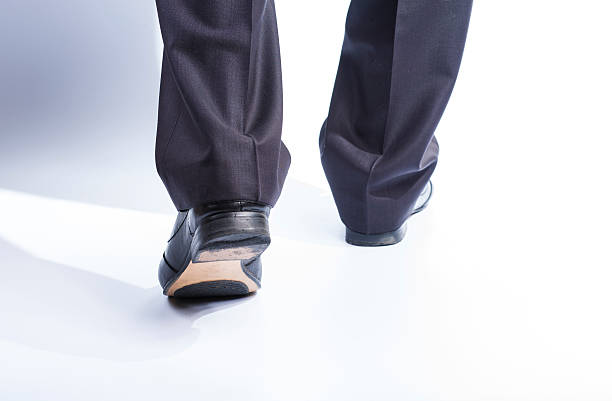 istock Man's legs in classic suit and leather shoes 533986096