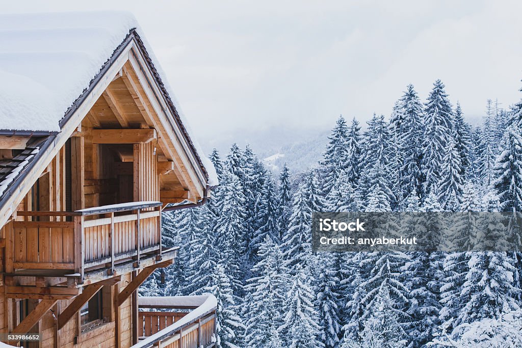 wooden house in winter mountains winter holidays, ski vacations background, wooden house under snow in the Alps Mountain Stock Photo