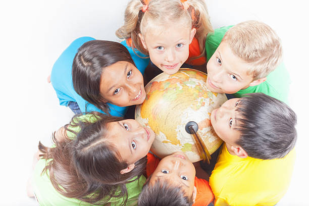 istock Group of international kids holding globe earth 533986890