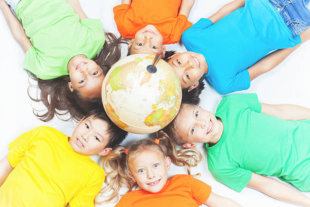 istock Group of international kids holding globe earth 533987332