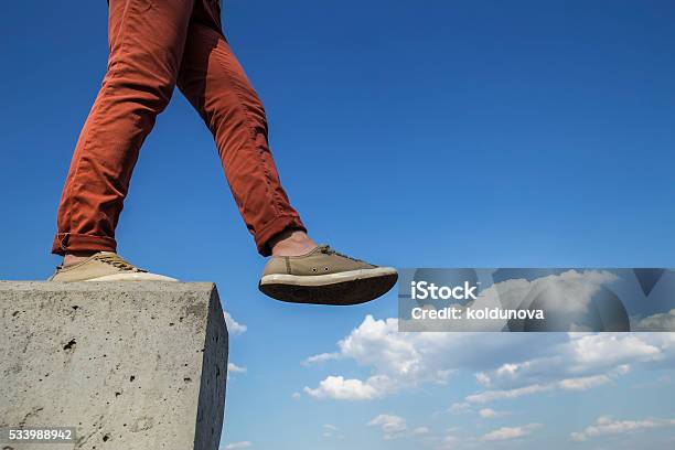 Person Makes Confident Step With Concrete Wall Stock Photo - Download Image Now - Activity, Adult, Adults Only