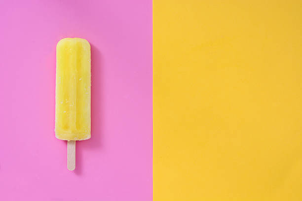 istock Lemon popsicle on pink and yellow background 533990946