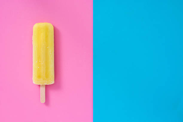 istock Lemon popsicle on pink and blue background 533991064