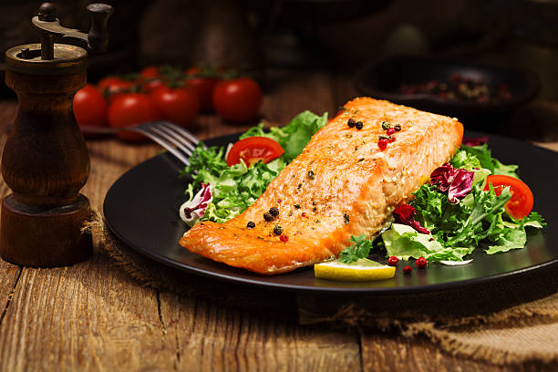 istock Baked salmon served with fresh vegetables. 533992536