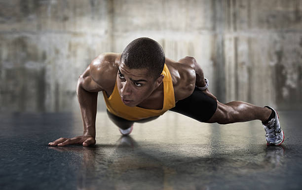 Sport. Young athletic man doing push-ups. Sport. Young athletic man doing push-ups. Muscular and strong guy exercising. push ups stock pictures, royalty-free photos & images