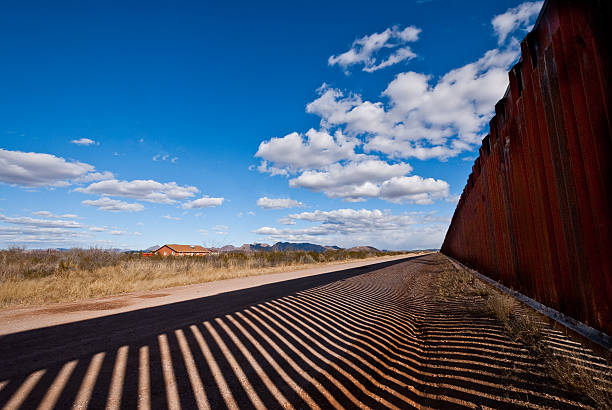 Shadows Cast Across the USA - Mexico Border The USA-Mexico Border Fence separates people in Douglas, Arizona, USA from their neighbors and family in Agua Prieta, Sonora, Mexico. jeff goulden border security stock pictures, royalty-free photos & images
