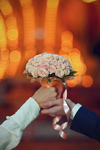 istock couple holding in hands weddings flowers 533996107