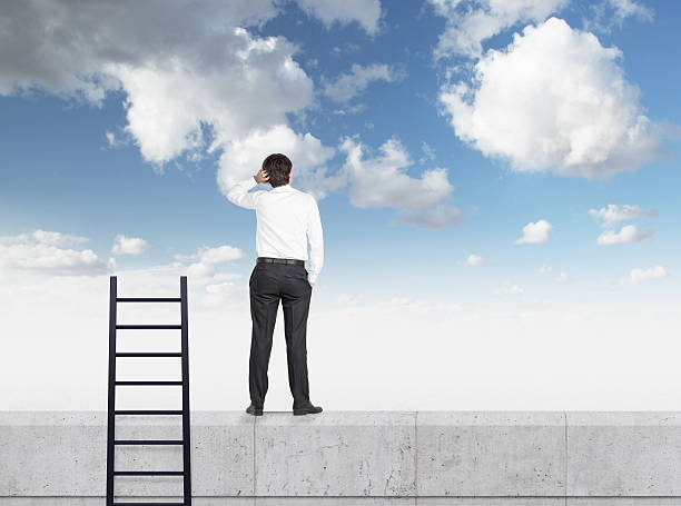 istock businessman in suit standing on wall 533996671