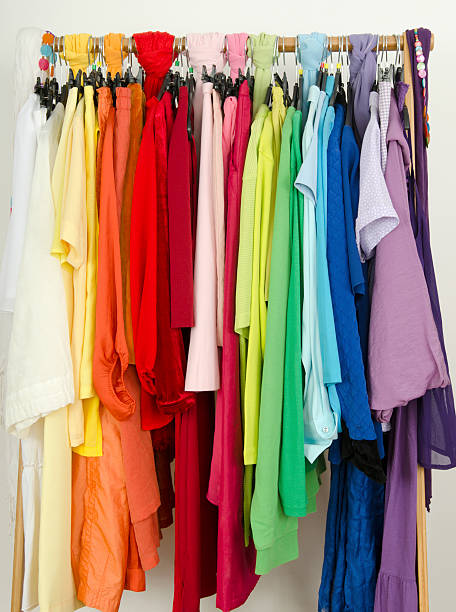 istock Closeup on color coordinated clothes on hangers in a store. 533996701