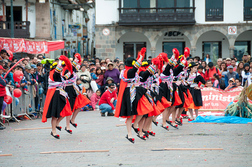 Сuzco, Peru - April 16, 2016: Dancers and spectators at a traditional dance festival in the Plaza De Armas in Cuzco, Peru.