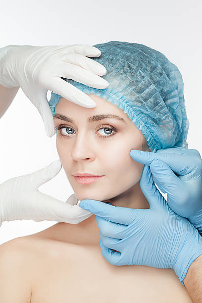 istock Plastic surgery concept. Doctor hands in gloves touching the beautiful 533997434
