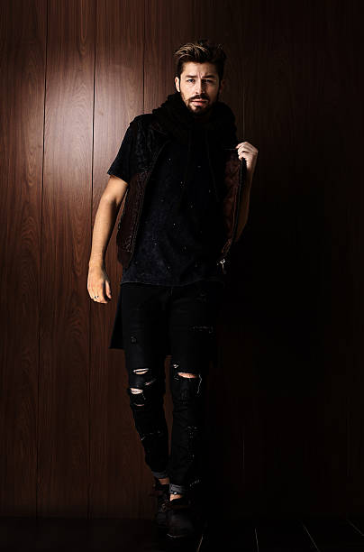 istock Handsome confident mature man with beard stands on wooden brown 533997674