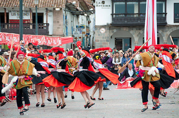 Сuzco, Peru - April 16, 2016: Dancers and spectators at a traditional dance festival in the Plaza De Armas in Cuzco, Peru.