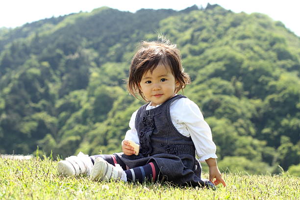 Japanese girl eating rice cracker (1 year old)