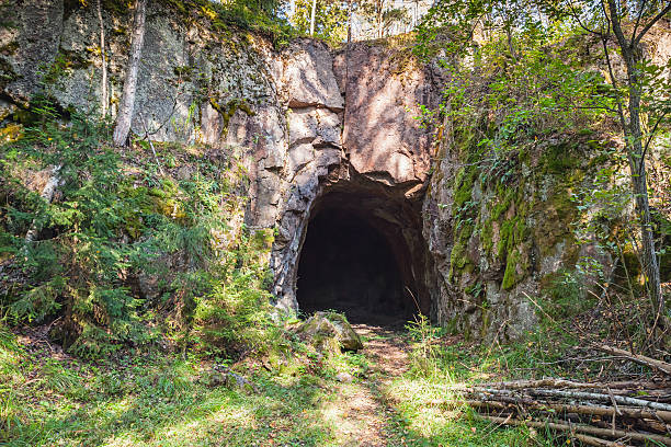 istock Entrance to dark cave in rock 533998986