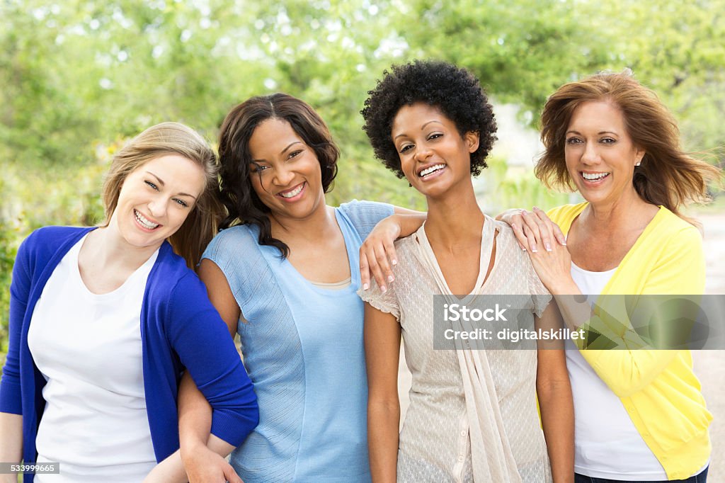 Diverse group of women Multi ethnic group of friends laughing. Only Women Stock Photo