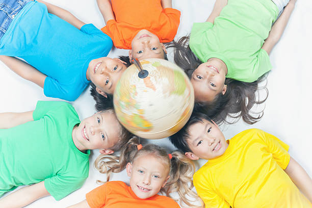 istock Group of international kids holding globe earth 534000510