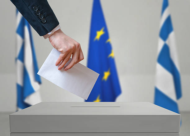 istock Election in Greece. Voter holds envelope above vote ballot. 534001018
