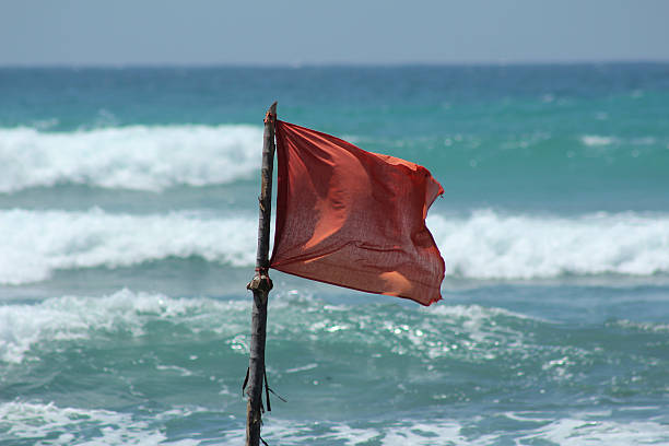 istock Red flag danger during a storm on the ocean 534001176