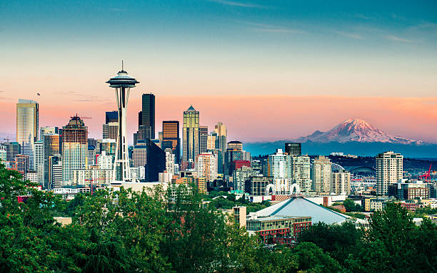 Seattle Skyline and Mount Rainier at Sunset Seattle Skyline and Mount Rainier at Sunset on a clear summer day. elliott bay photos stock pictures, royalty-free photos & images