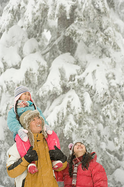 istock Girl and parents in snow 534002499