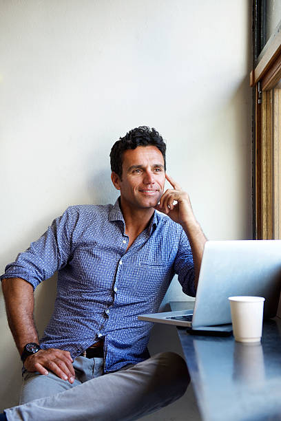 istock Handsome man sitting with laptop at cafe 534002520