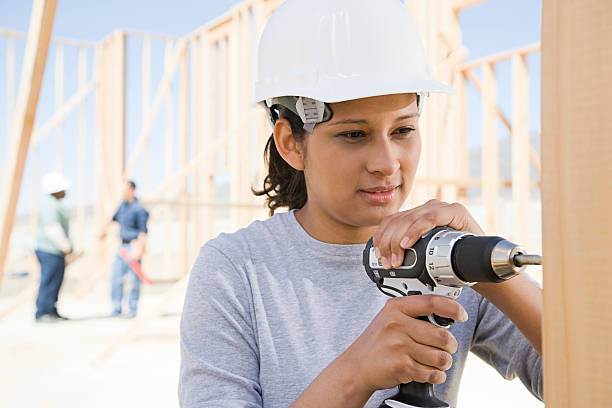 Female builder drilling A female builder drilling dental drill stock pictures, royalty-free photos & images