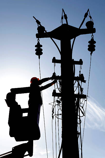 istock sihouette of worker checking the electric line 534002769