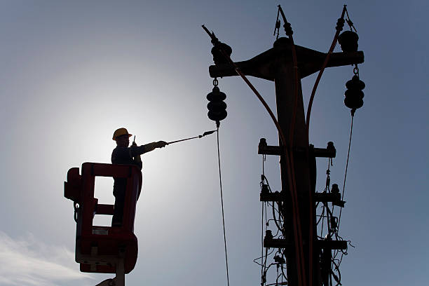 istock silhouette of worker checking the electric line 534002771