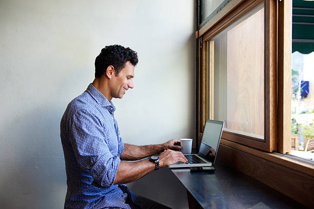 istock Modern business man sitting at cafe with laptop 534003820