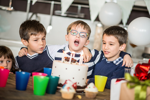 Little boy birthday party: blowing out candles