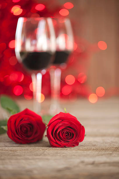 istock Valentine's day wine, red roses on old wood rustic background 534024259