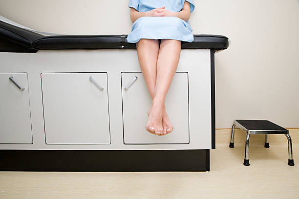 Patient sitting on treatment couch Patient sitting on treatment couch medical examination room stock pictures, royalty-free photos & images