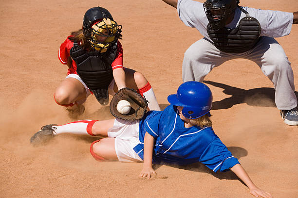 istock Softball Player Sliding Into Home Plate 534025973