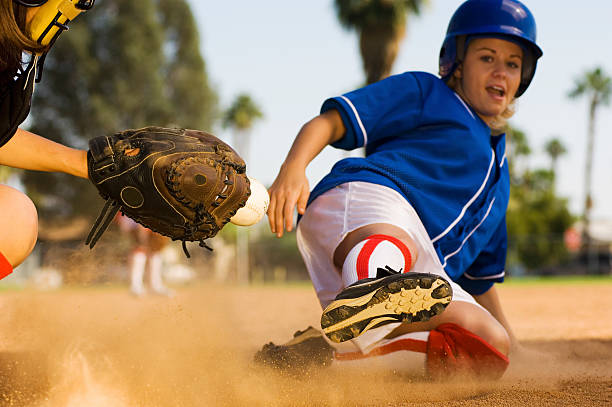 istock Softball Player Sliding Into Home Plate 534025991