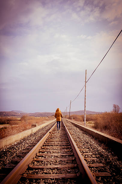 istock Young woman walking on a railway. Rural setting 534026689