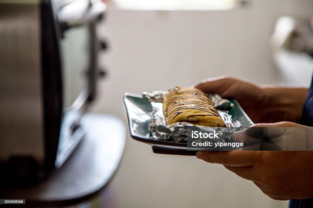 hand taking homemade cake from oven Bakery Stock Photo